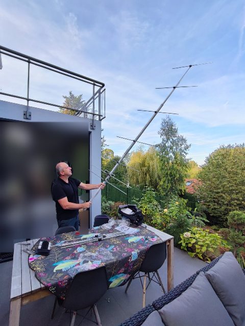 Build, October 2023: a Yagi held at arm's length on the terrace, the parts spread out on the table