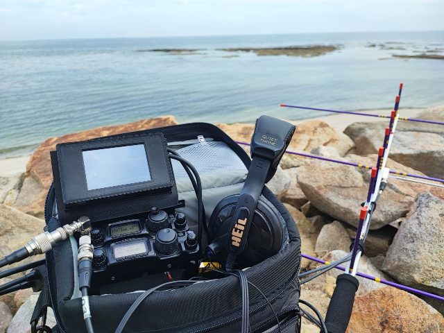 The portable station in its bag, by the sea